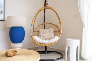 A room with a hanging chair, a lamp, a stool, and a bowl on a round table. - Brand NEW Private Villa, Huge Pool, Beach Access (Kecamatan Kuta Utara)