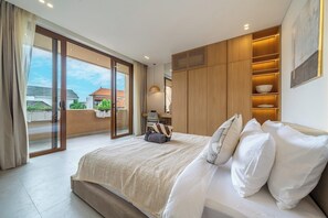 A bedroom with a large bed, a sliding glass door to a balcony, and a wooden wardrobe with shelves. - New Chic Berawa Villa • Pool • 2BR • Walk to Beach (Kabupaten Badung)