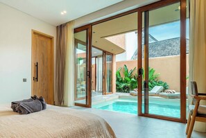 A bedroom with a large bed, a sliding glass door leading to a pool area. - New Chic Berawa Villa • Pool • 2BR • Walk to Beach (Kabupaten Badung)