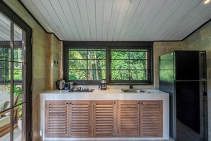A modern kitchen with a large island, built-in appliances, and a view through a window. - Cozy Ubud's 2BR Escape with Huge Pool & Patio (Ubud)