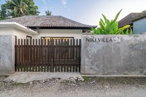 A villa with a gated entrance, a concrete wall with the name 'NIKI VILLA' on it, and a tropical plant in the background. - Cozy 2BR in Ubud w Rice Field&Temple Views+Pool (Kecamatan Ubud)