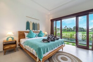 A bedroom with a bed, nightstands, a view of a swimming pool, and a large sliding glass door. - Brand NEW Villa+Rice Fields View+Huge Pool+4BDR (Kecamatan Kuta Utara)