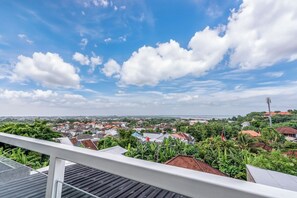 A balcony with a view of a residential area, including houses and greenery. - Chic 3BR in Nusa Dua - Ocean View, Cinema, Rooftop (Kabupaten Badung)