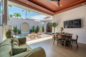A modern living room with a pool, outdoor seating, and a dining area. - Brand NEW Paradise Villa, Huge Pool, Best Location (Kabupaten Badung)