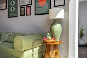 A green sofa with a side table holding a bowl of fruit and a lamp. - Brand NEW Paradise Villa, Huge Pool, Best Location (Kabupaten Badung)