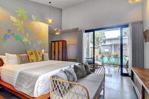 A bedroom with a bed, a sofa, a view of a swimming pool, and a mural on the wall. - Tropical 4BR Oasis w Huge Pool+Gazebo, Ubud's Best (Kabupaten Gianyar)