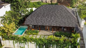 A house with a swimming pool, surrounded by lush greenery and a sloped roof. - Serene 2BR Escape in Prime Ubud - Pool+Lush Jungle (Kabupaten Gianyar)