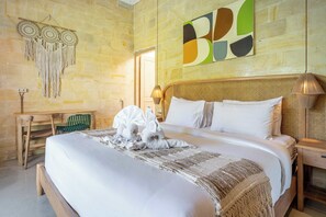A hotel room with a large bed, a desk, and a wall with a geometric artwork. - Serene Ubud 2BR Stay • Garden Bath • Private Pool (Ubud)