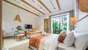 A bedroom with a bed, a desk, and a television. - Boho 1BR Flat in Central Ubud w Pool, Garden&Patio (Kabupaten Gianyar)