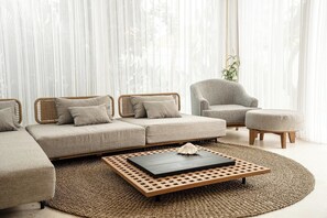 A living room with a sectional sofa, a chair, an ottoman, and a coffee table. - Peaceful 3BR Villa in Lush Ubud, Large Pool&Garden (Kabupaten Gianyar)