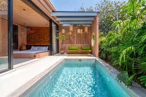 A modern outdoor pool area with a built-in bed and seating. - Serene 1BR Stay in Ungasan - Perfect for Couples! (South Kuta)