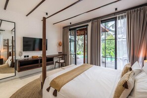 A modern hotel room with a large bed, a flat-screen TV, a desk, and a view of the outdoors. - Serene 2BR Ubud Oasis w Infinity Pool&Garden Bath (Ubud)