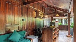 A wooden interior with a sofa, a small table, and a sign reading 'Hidden Garden Spa'. - Brand NEW Hidden 2BR Gem in Ubud w Pool & Patio (Kabupaten Gianyar)