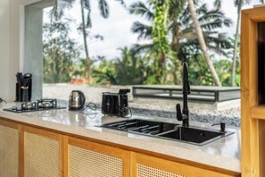 A kitchen with a sink, a kettle, and a coffee maker. - 3BR Villa in Jungle Ubud • Private Pool & Patio (Gianyar Regency)