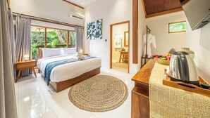 A bedroom with a bed, a bedside table, a coffee table, a TV, and a view of the outdoors. - Chic 1BR in Top Ubud's Spot w Spacious Pool+Garden (Ubud)