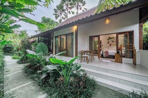 A modern house with a covered patio, large windows, and a garden with tropical plants. - Cozy 1BR Stay w Pool, Garden & Patio, Central Ubud (Kabupaten Gianyar)