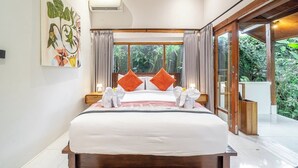 A hotel room with a large bed, two pillows, a window with curtains, and a view of greenery outside. - Cozy 1BR Stay w Pool, Garden & Patio, Central Ubud (Kabupaten Gianyar)