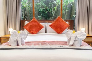 A hotel room with a bed, two pillows, two nightstands, and a window with a view of greenery. - Boutique 1BR in Central Ubud w Pool, Patio&Balcony (Kabupaten Gianyar)