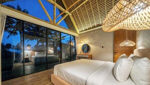 A bedroom with a large bed, a glass wall, and a ceiling with a woven design. - Brand NEW 1BR Villa+Huge Pool+Jungle View+Top Spot (Gianyar Regency)
