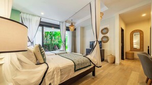 A bedroom with a bed, curtains, a television, and a view of greenery outside. - Serene Room in Mesari Hotel Ubud w Rice Field View (Gianyar Regency)