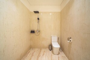 A bathroom with a shower, toilet, and a hand dryer. - Stylish Flat with Kitchen in Peaceful Part of Ubud (Gianyar Regency)
