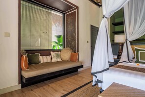 A bedroom with a bed, a sofa, and a window with blinds. - Designer 1BR Villa in Serene Ubud - Pool + Garden (Gianyar Regency)
