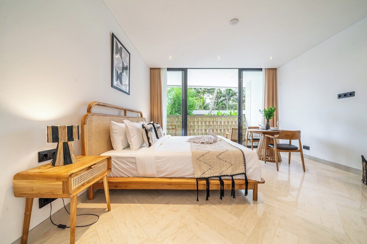 A modern bedroom with a wooden bed, a desk, and a chair.