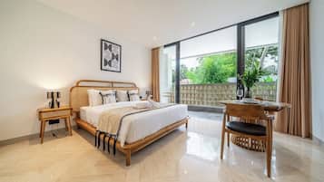 A spacious bedroom with a large bed, a bedside table, a chair, and a view of the outdoors.
