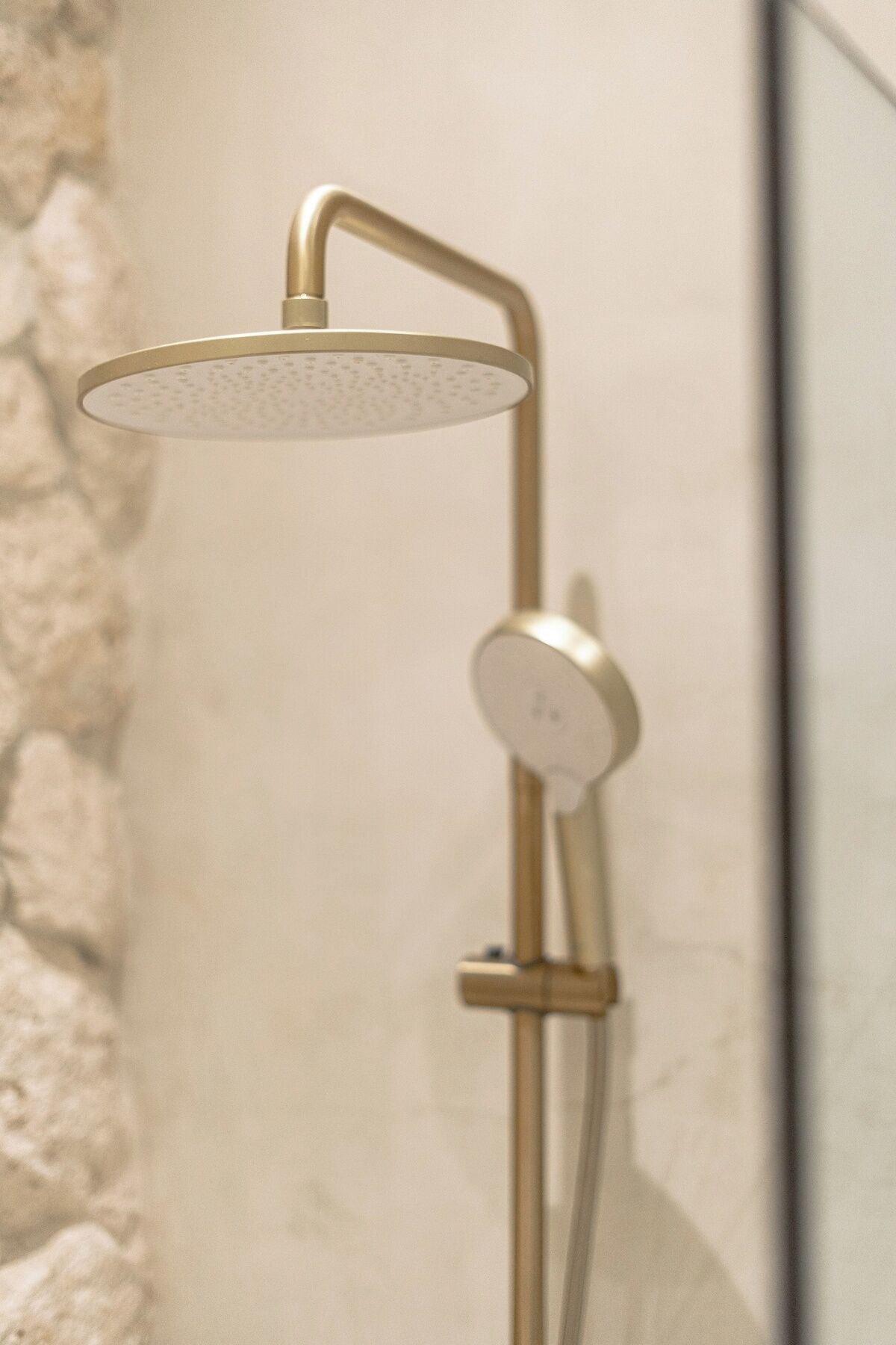 A modern shower with a curved design and a control panel.
