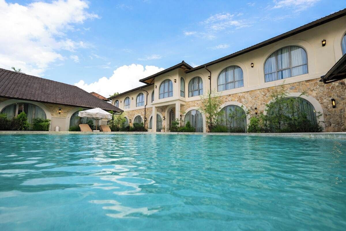 A swimming pool with a building in the background.