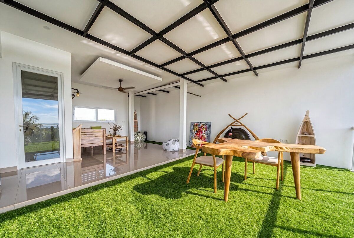 A modern interior with a dining area, a fireplace, and a view of the outdoors.