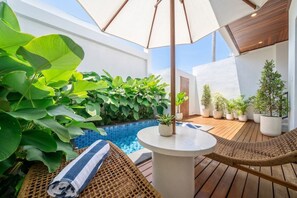 A rooftop terrace with a pool, wicker furniture, and potted plants. - Designer 3BR Villa by Sanur Beach • Pool & Rooftop (Denpasar Selatan)