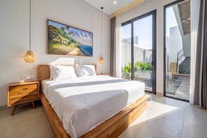 A modern bedroom with a large bed, a painting of a beach scene, a nightstand, and a view of the outdoors through a glass door. - Cozy 2BR Villa • 300m to Sanur Beach+Pool+Rooftop (Kota Denpasar)