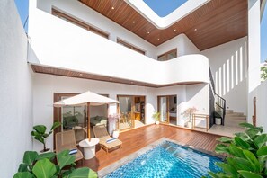 A modern two-story house with a swimming pool, outdoor seating, and a staircase. - Chic 3BR Villa 300m to Sanur Beach • Pool & Patio (Kota Denpasar)