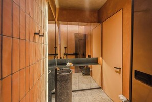 A modern bathroom with a large mirror, a sink, and a trash can. - Tropical 2BR Villa in Canggu • Beach Nearby • Pool (Kabupaten Tabanan)