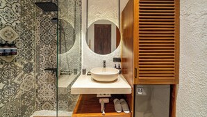 A bathroom with a large mirror, a sink, and a shower. - Tropical 1BR Stay in Ubud w Pool, Patio & Kitchen (Gianyar Regency)