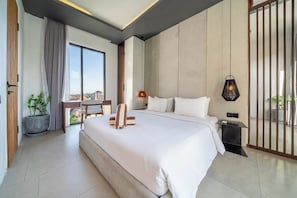 A modern bedroom with a large bed, a desk, and a view of the city. - Modern 2BR Flat in Ubud w Pool, Garden & Kitchen (Kabupaten Gianyar)
