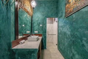 A bathroom with a large mirror, a sink, and a door leading to another room. - Tropical 2BR Villa w Beach Nearby, Patio & Pool (Mengwi)