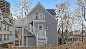 A two-story house with a central staircase and a small porch.
