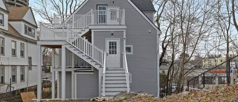 A two-story house with a central staircase and a small porch.