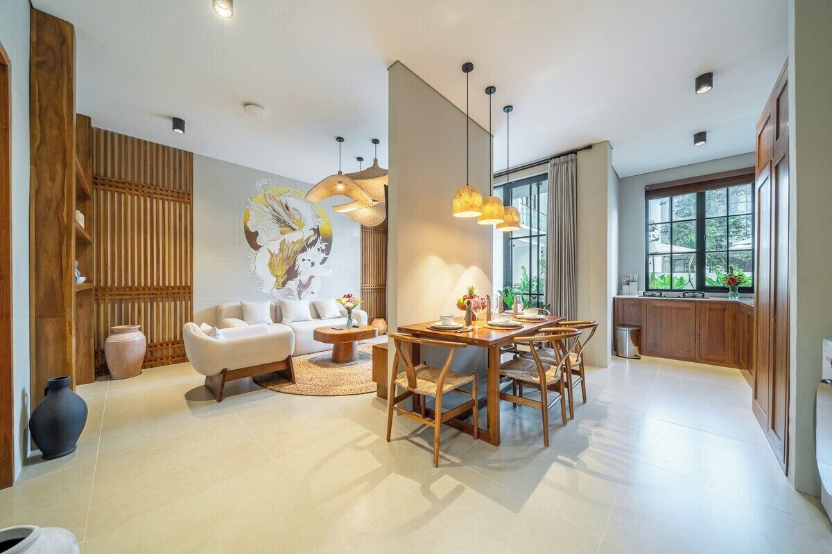 A modern interior with a dining area, a sofa, and a large window.