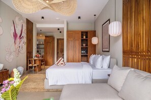 A hotel room with a bed, a sofa, a dining area, and a kitchen. - Luxe 1BR in Ubud w Pool, Private Kitchen & Balcony (Gianyar Regency)