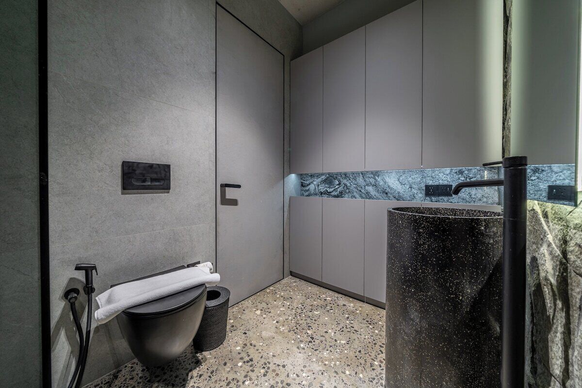 A modern bathroom with a toilet, bidet, and shower.