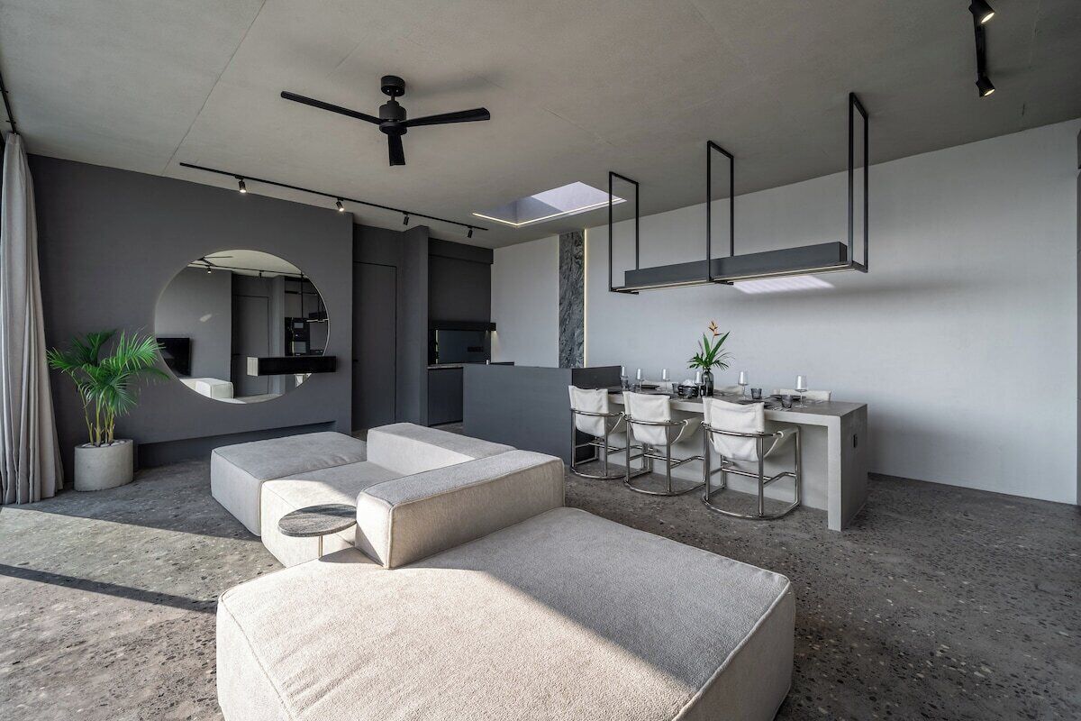 A modern interior with a seating area, a kitchen, and a dining space.