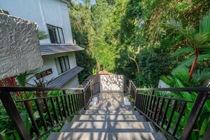 A staircase leading to a building surrounded by lush greenery. - Cozy 1BR Villa in Lush Ubud w Pool, Patio & Garden (Gianyar Regency)