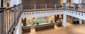 A multi-level hotel lobby with a reception desk, a staircase, and a view of the surrounding area. - Margaritaville Vacation Club - St. Thomas USVI Luxury Wyndham Presidential Suite (St. Thomas)