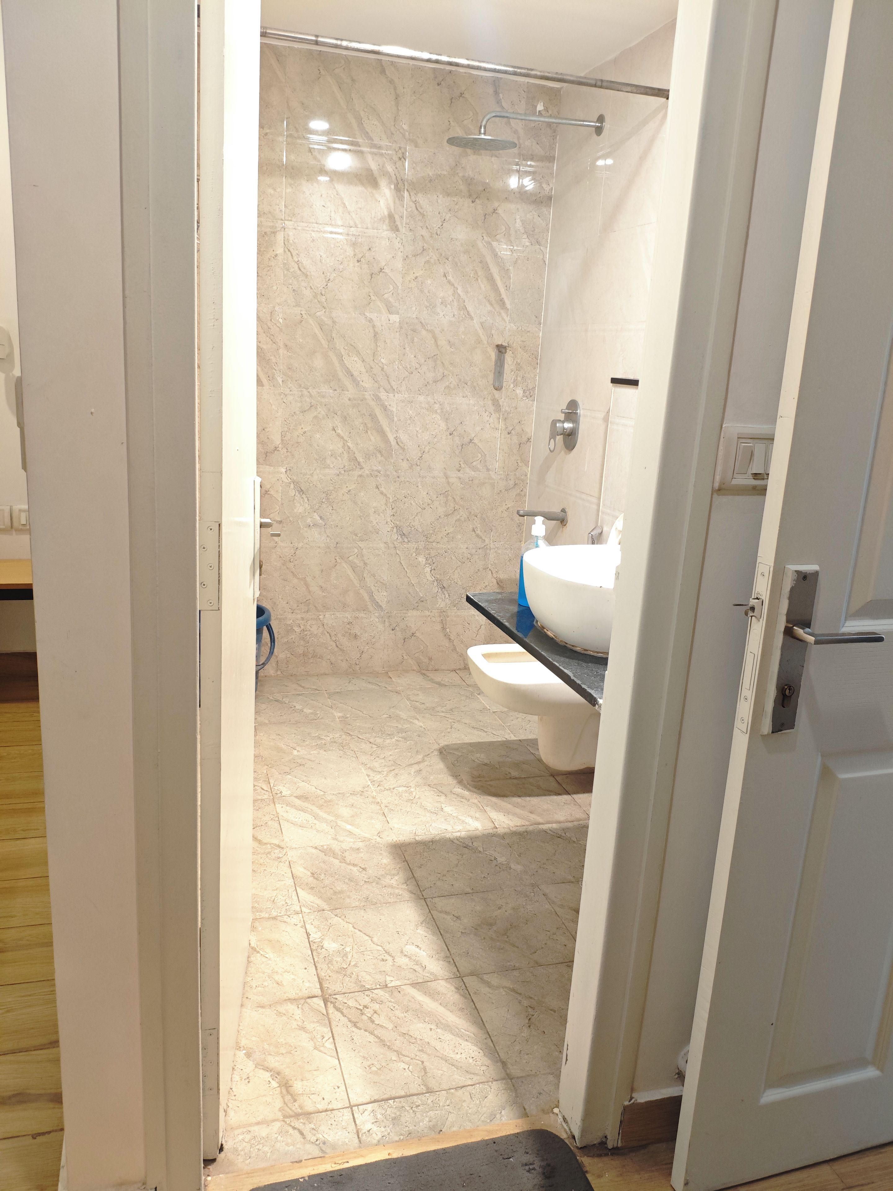 A bathroom with a shower, toilet, and sink.