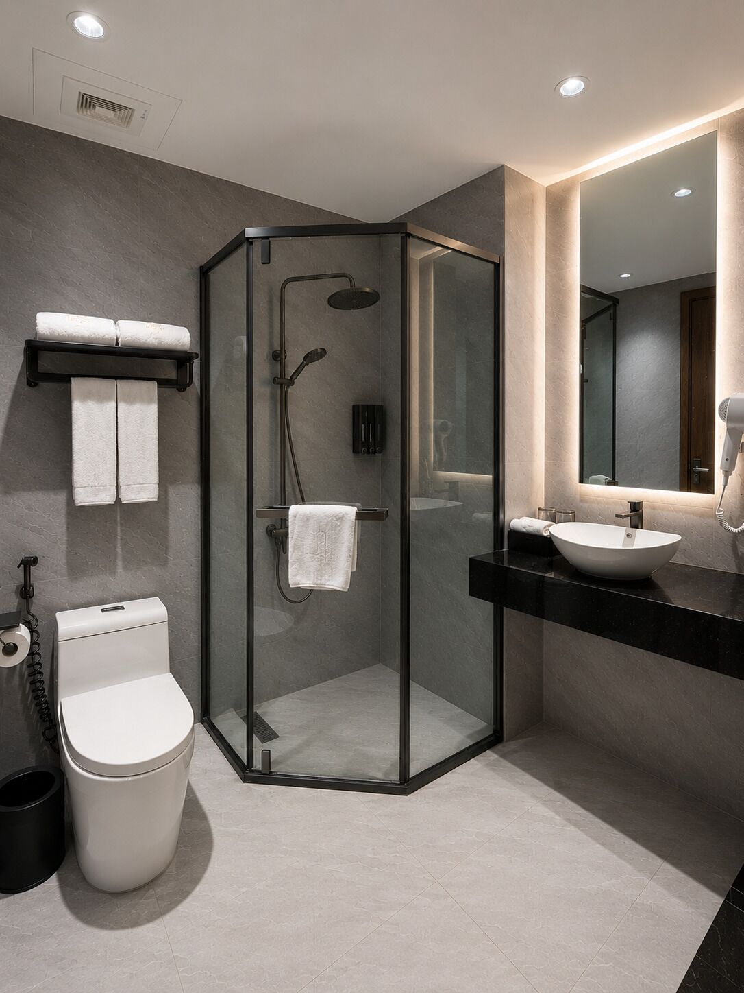 A modern bathroom with a glass-enclosed shower, a toilet, a sink, and a mirror.