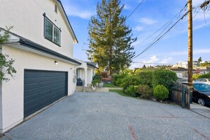 A residential property with a garage, a driveway, and a well-maintained garden.