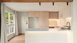 A modern kitchen with a central island, wooden cabinets, and a view to the left. - Casa Vista, Dandenong Ranges forest retreat (Kalorama)